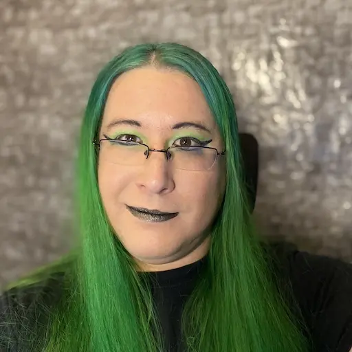 Hiromi looks at the camera. Her hair is very green.